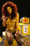 Melina is painted gold and posed with the gold belt