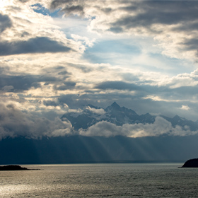 Rays of sunlight through the clouds in the Fjords of Alaska near Skagway.