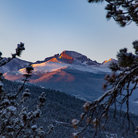 First light hits the snow peaked mountains in Estes Park, Utah.